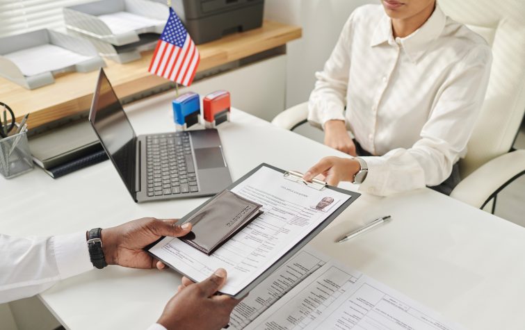 Immigration specialist reviewing visa and work authorization documents in response to Supreme Court TPS rulings affecting global mobility programs