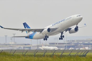 Commercial aircraft taking off from an international airport representing employee departure for a corporate relocation or global mobility assignment