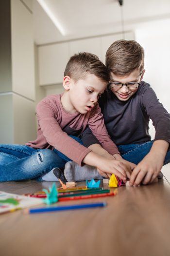 Two children playing before a family relocation