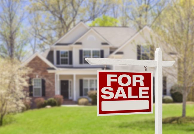 Home with a for-sale sign representing an Amended Value relocation program