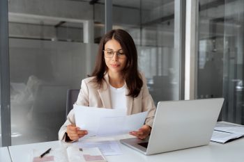 Business professional reviewing financial documents representing the $850,000 to $1.25 million cost of a failed international assignment