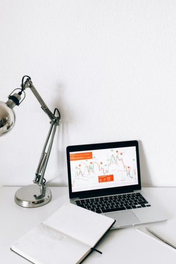 Laptop displaying data analytics charts representing AI-powered global mobility cost forecasting and program performance tracking